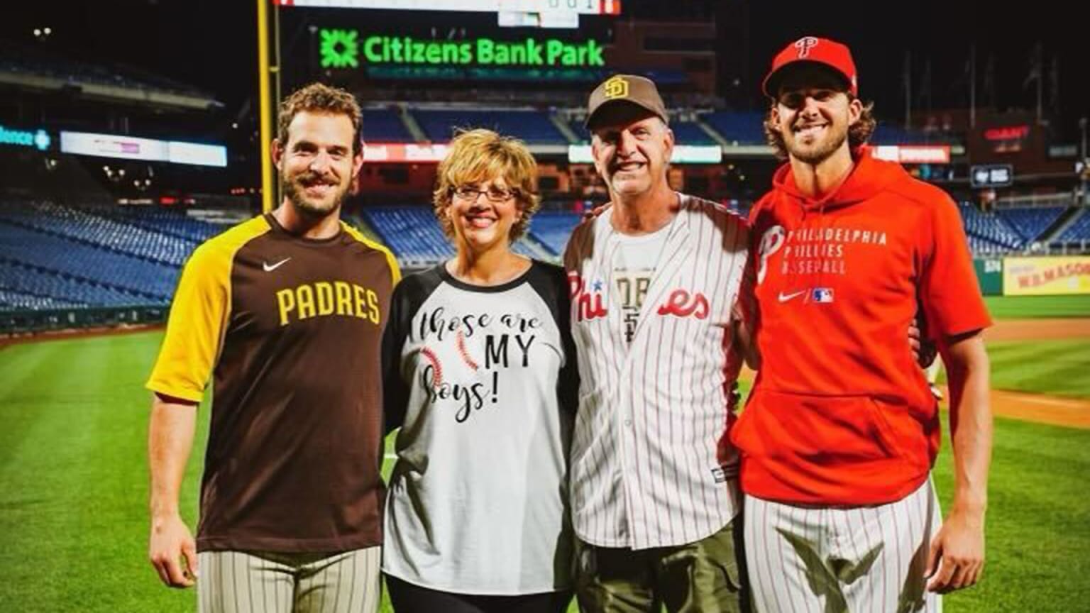 Austin and Aaron Nola pose for a photo with their parents