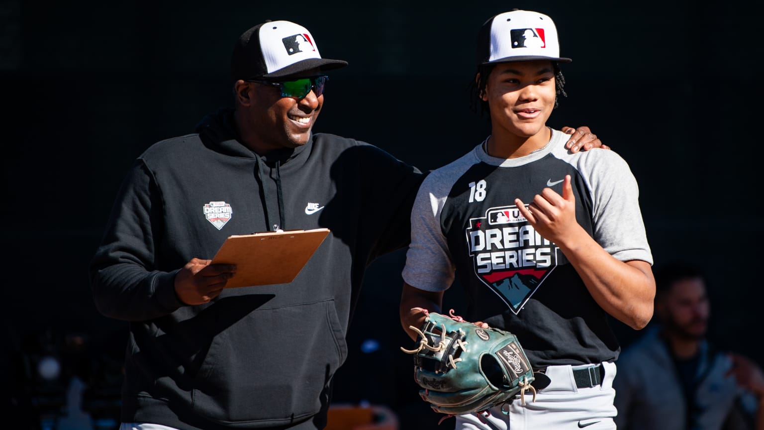 Darren Oliver instructs high school player Bryce Robinson