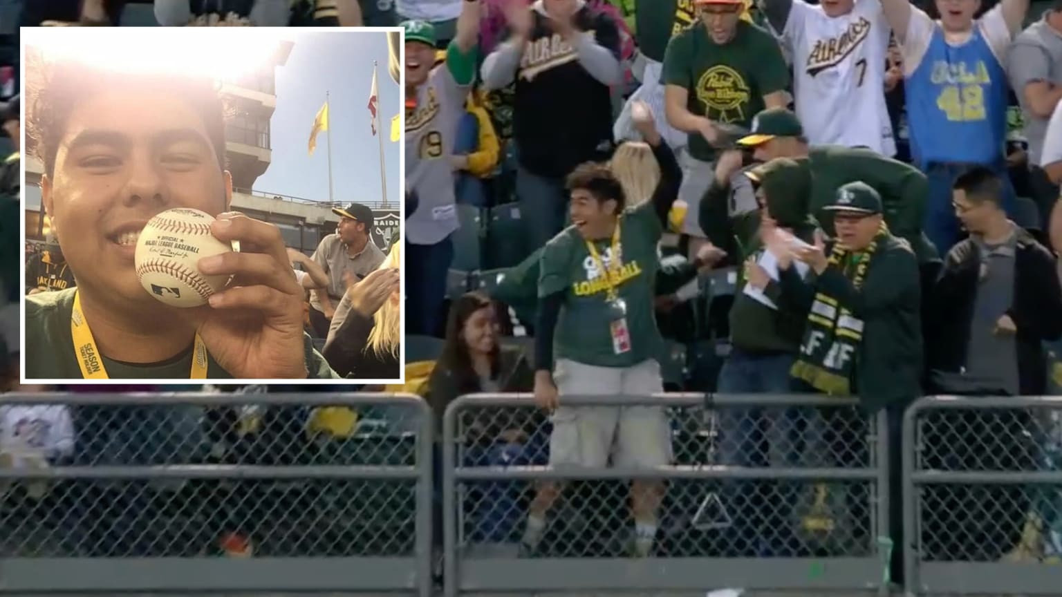 A fan holds up a home run ball