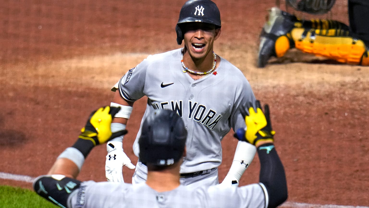 Oswaldo Cabrera is greeted at home plate after hitting a home run