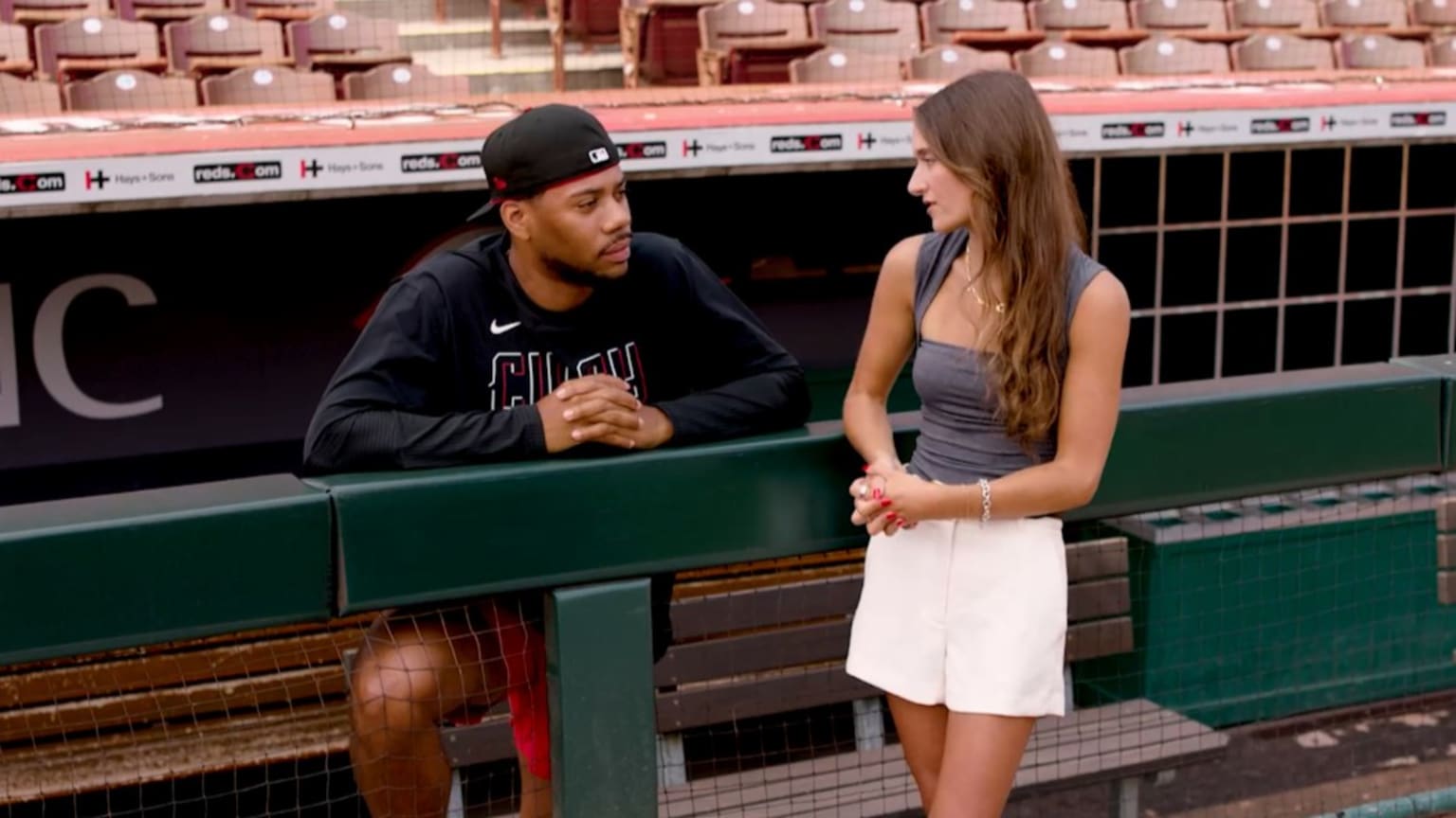 A screengrab of Hunter Greene and Kait Maniscalco talking in a dugout