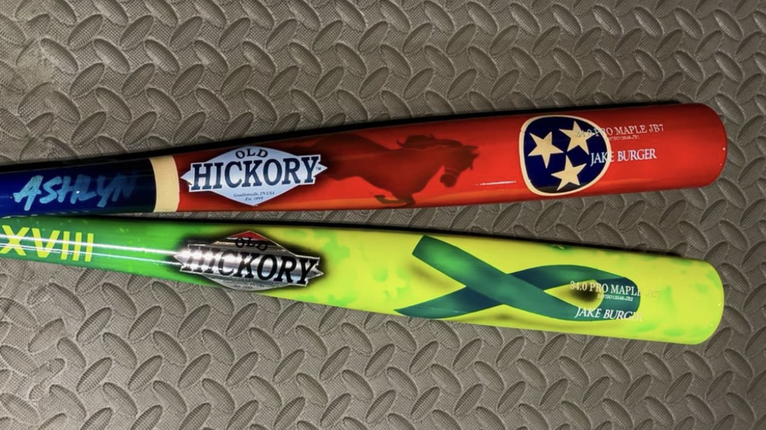 Two of Jake Burger's custom baseball bats