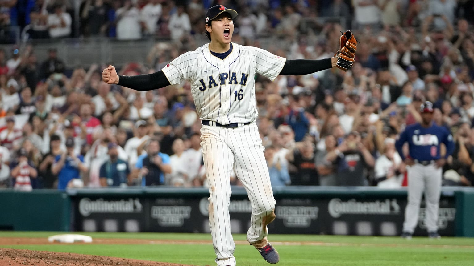 Shohei Ohtani spreads his arms wide in celebration