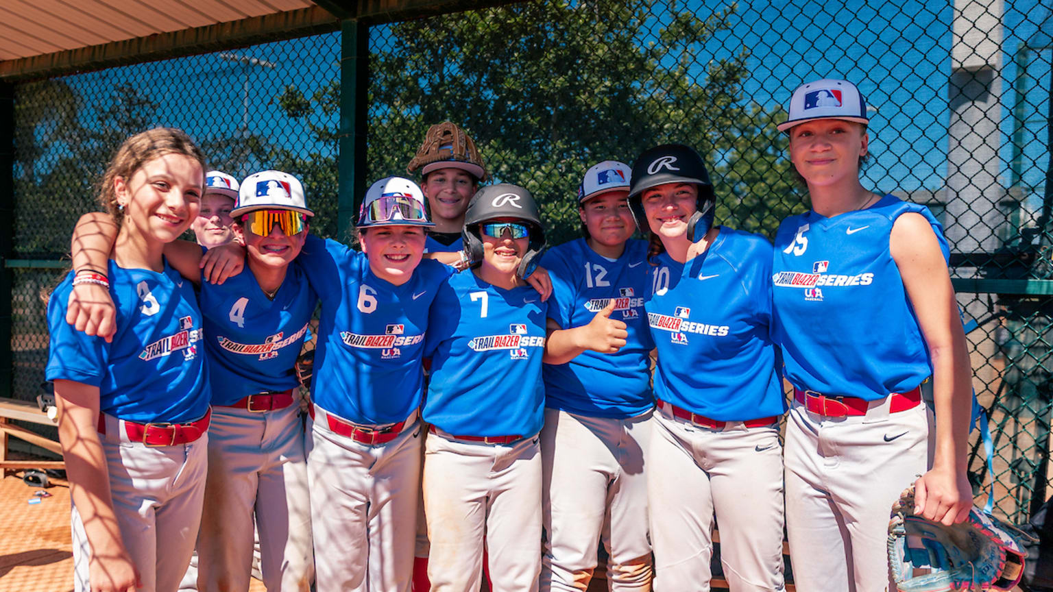 Youth players smile in the dugout