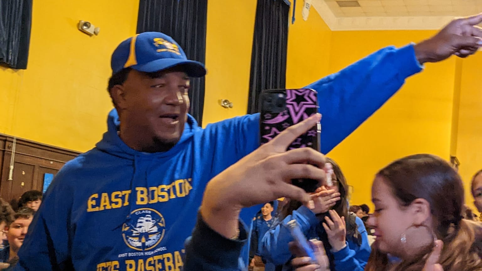 Pedro Martinez points while standing among a group of students