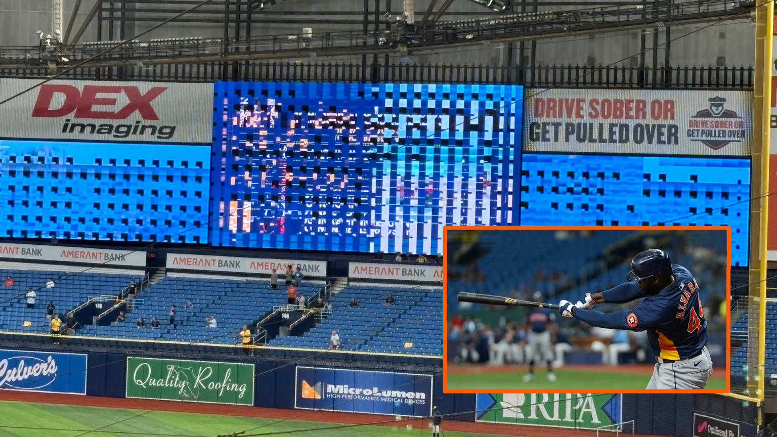 Broken scoreboard at Tropicana Field with an inset of Yordan Alvarez