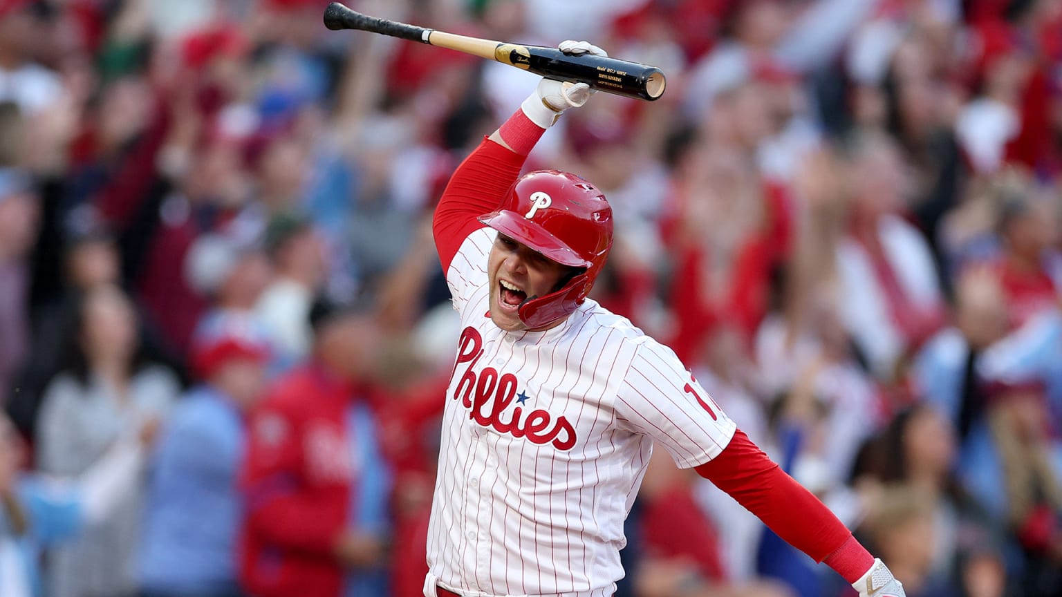 Rhys Hoskins prepares to throw his bat to the ground after a home run