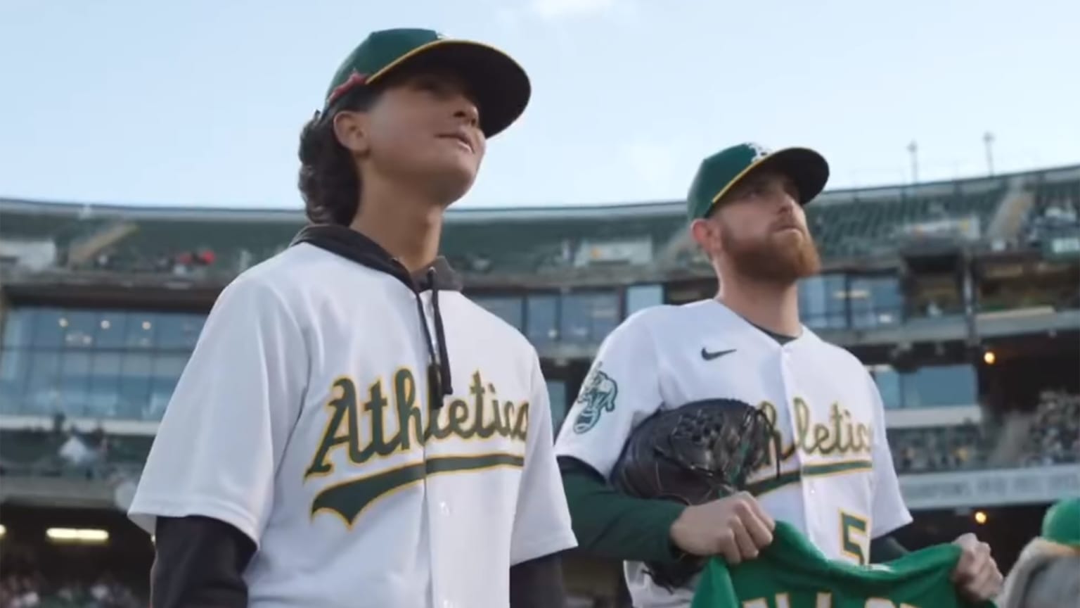 A's fan Gabriel De La Cruz and pitcher Paul Blackburn gaze up