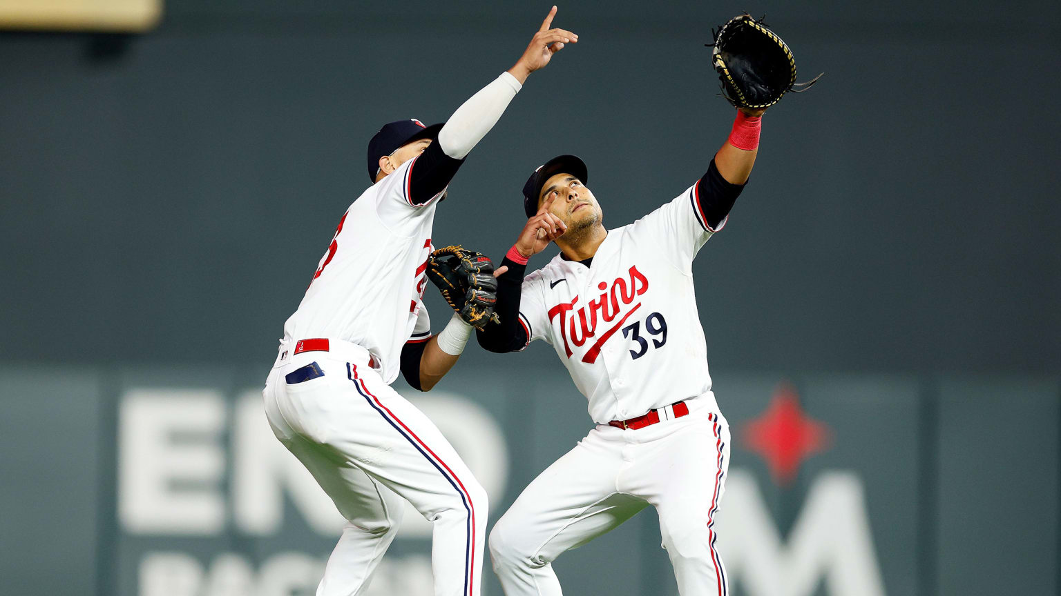 Pair of Twins celebrate a victory by pointing to the sky