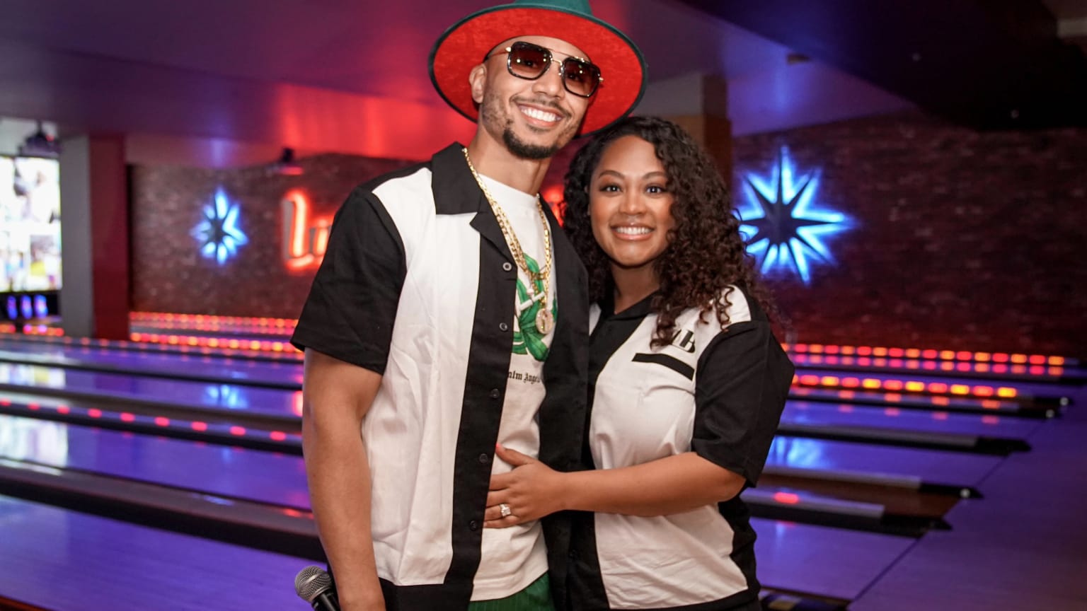 Mookie Betts poses for a photo with his wife Brianna at a bowling alley