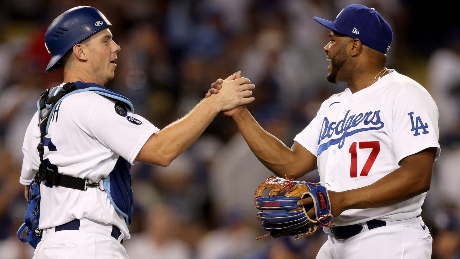 Dodgers catcher Will Smith and Hanser Alberto clasp hands to celebrate a win