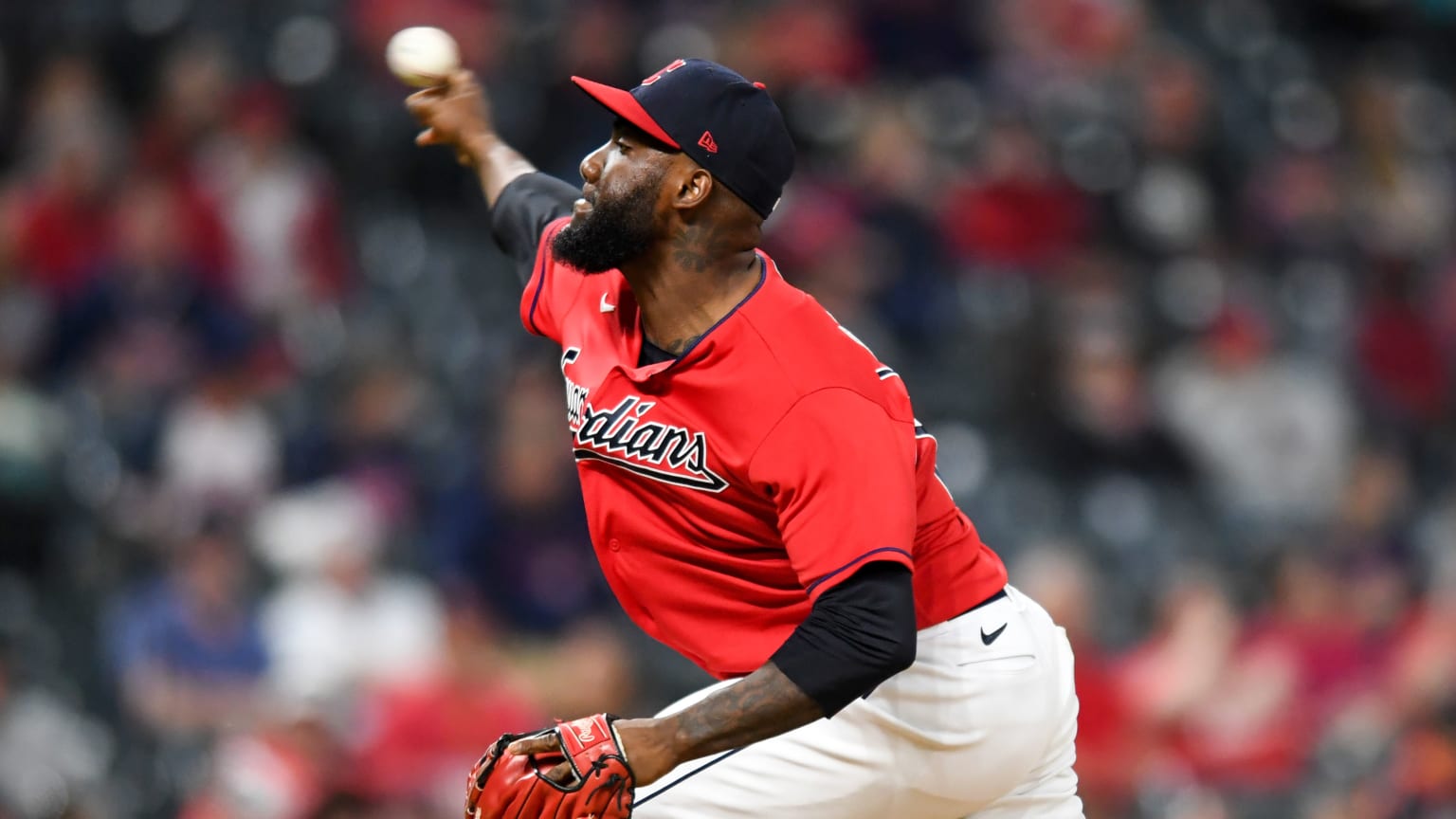 Enyel De Los Santos releases a pitch in the Guardians' red alternate jersey
