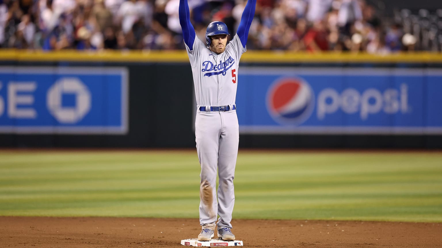 Freddie Freeman raises his arms while standing on second base