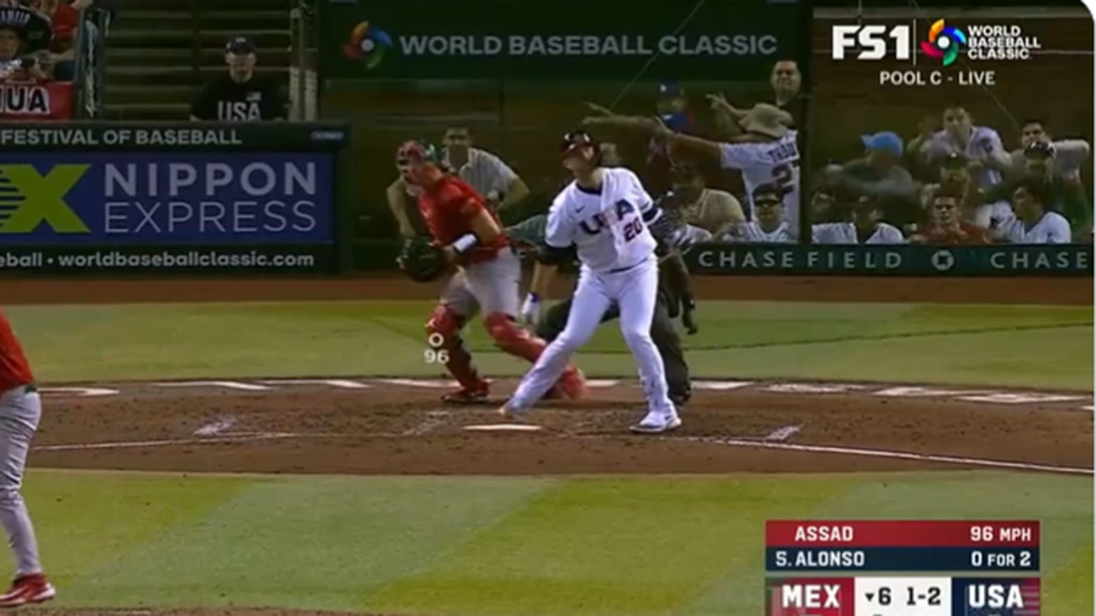 A screenshot of a batter finishing a swing and fans behind the plate signaling a strikeout