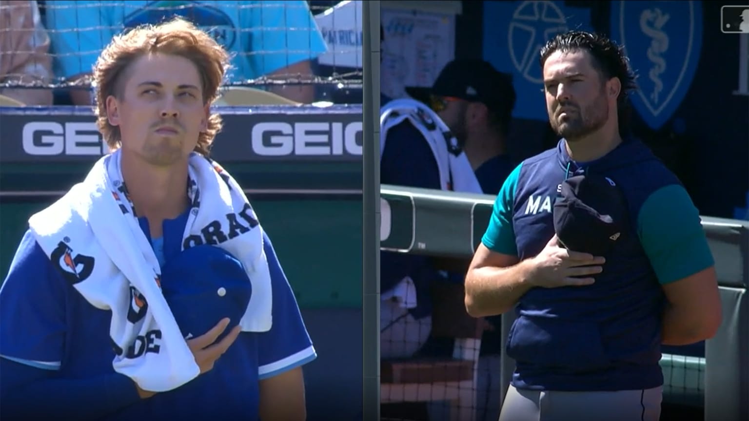 Luke Weaver and Robbie Ray stand with their caps over their hearts during the national anthem