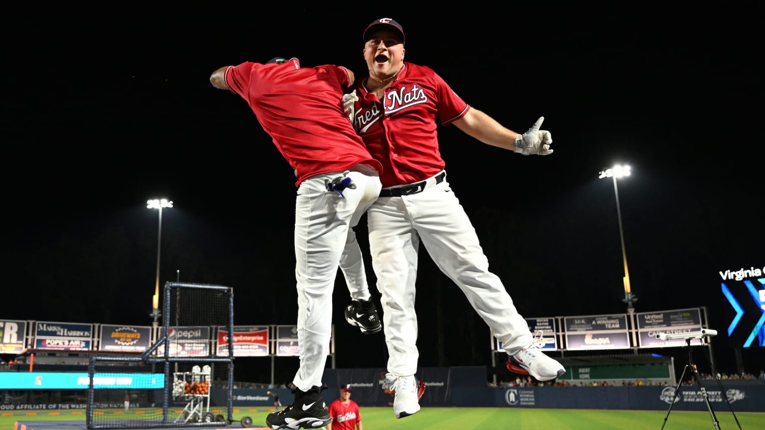 Two players celebrate near home plate
