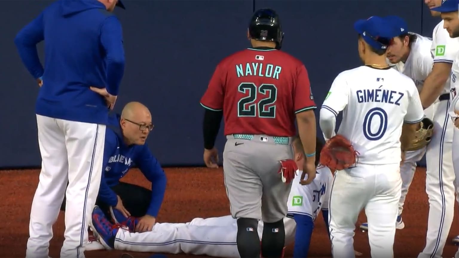 The D-backs' Josh Naylor checks on Blue Jays outfielder Myles Straw