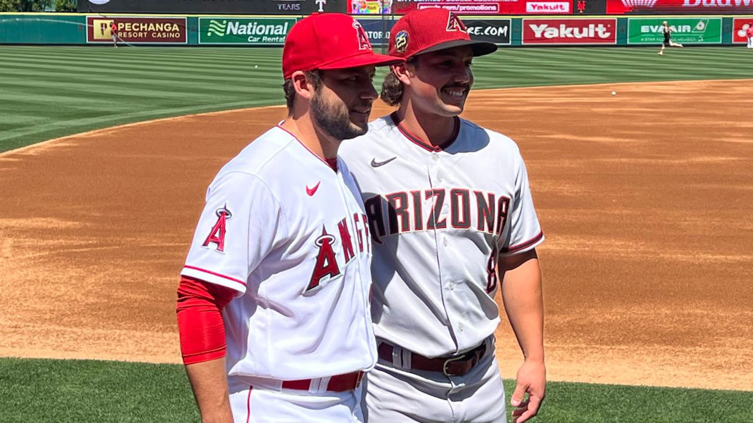 David and Dominic Fletcher pose for a pregame photo on the field