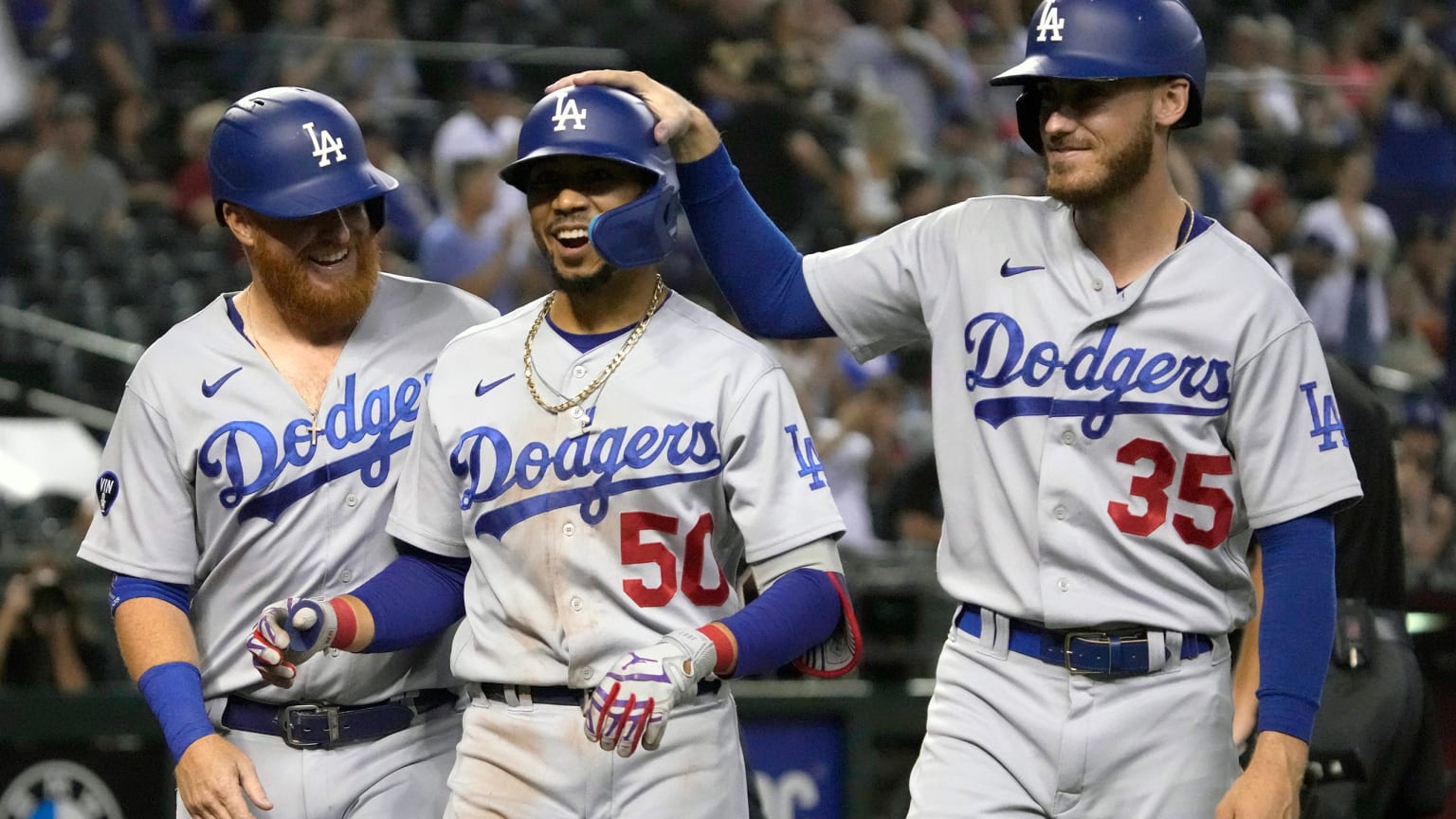 Dodgers Justin Turner, Mookie Betts and Cody Bellinger celebrate after a Betts home run