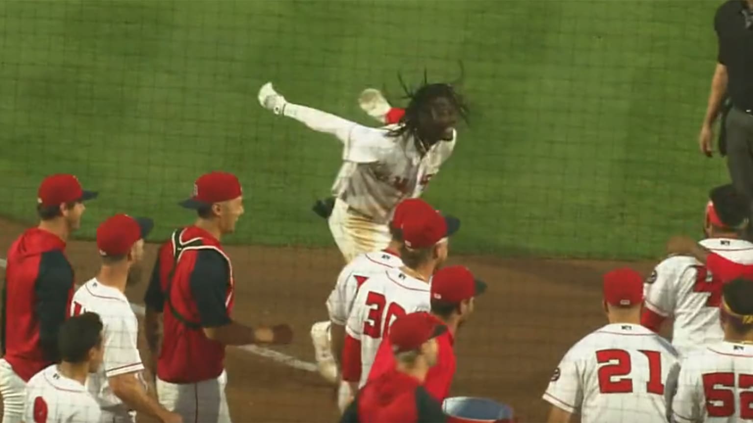 A video screenshot of Elly De La Cruz approaching home plate in celebration