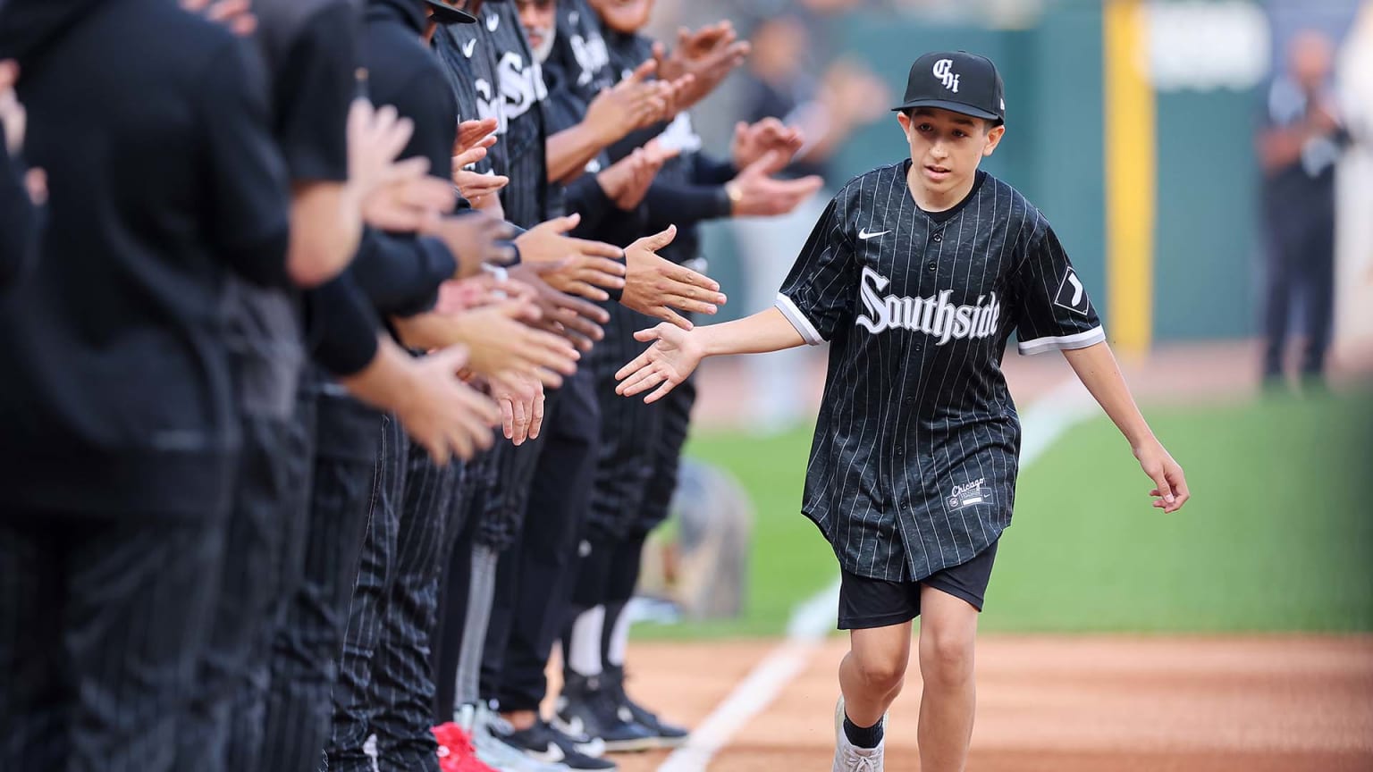 14-year-old fan Brady Nelson slaps hands with White Sox players