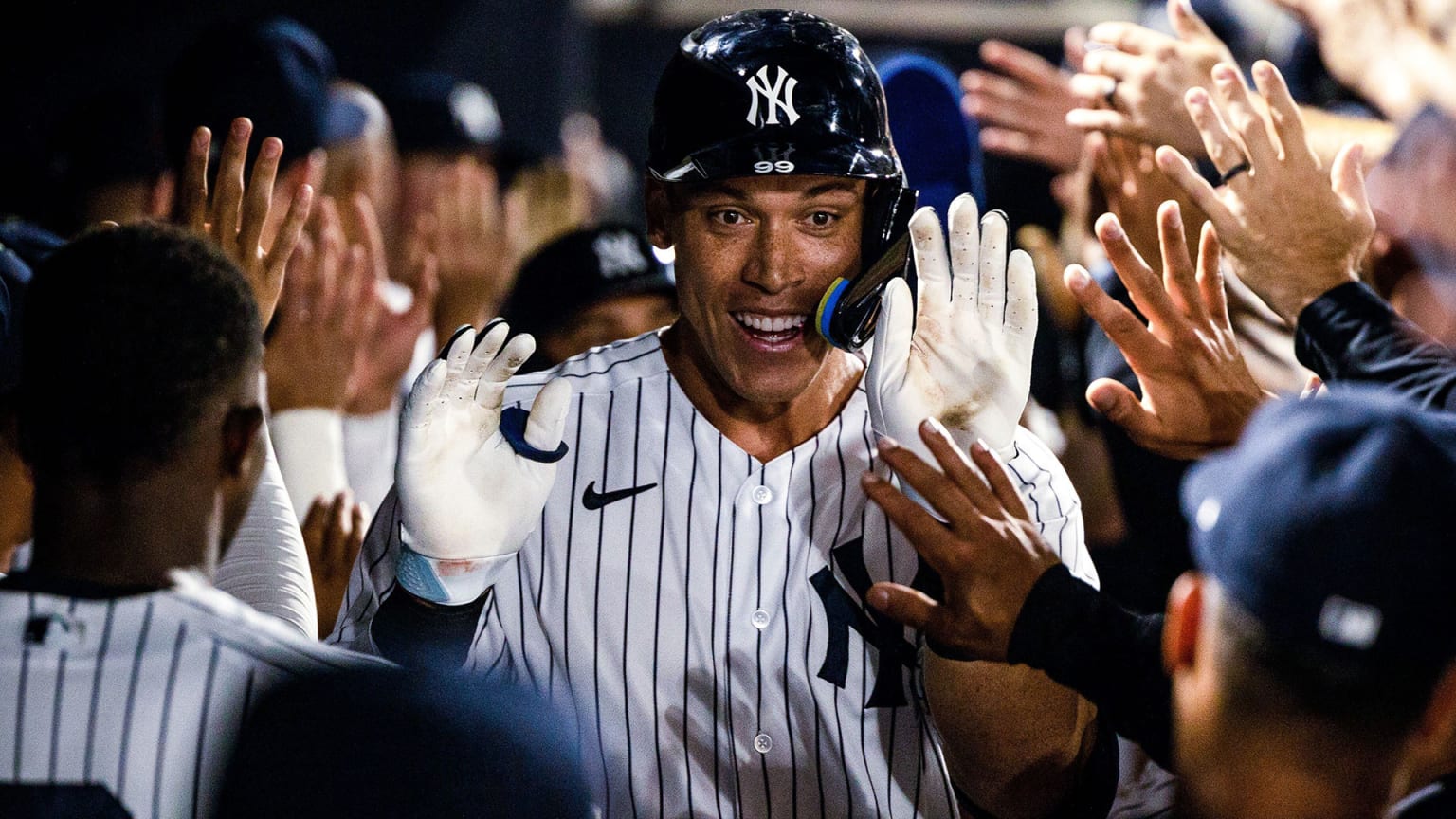 Aaron Judge receives high-fives in the Yankees dugout