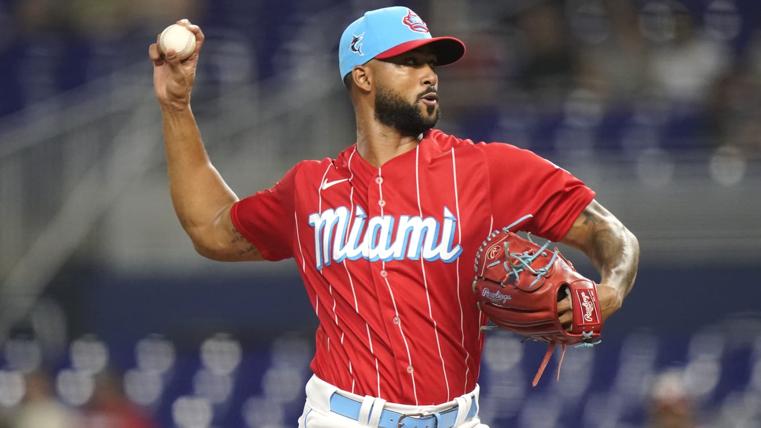 Sandy Alcantara pitches in a red jersey and light-blue cap