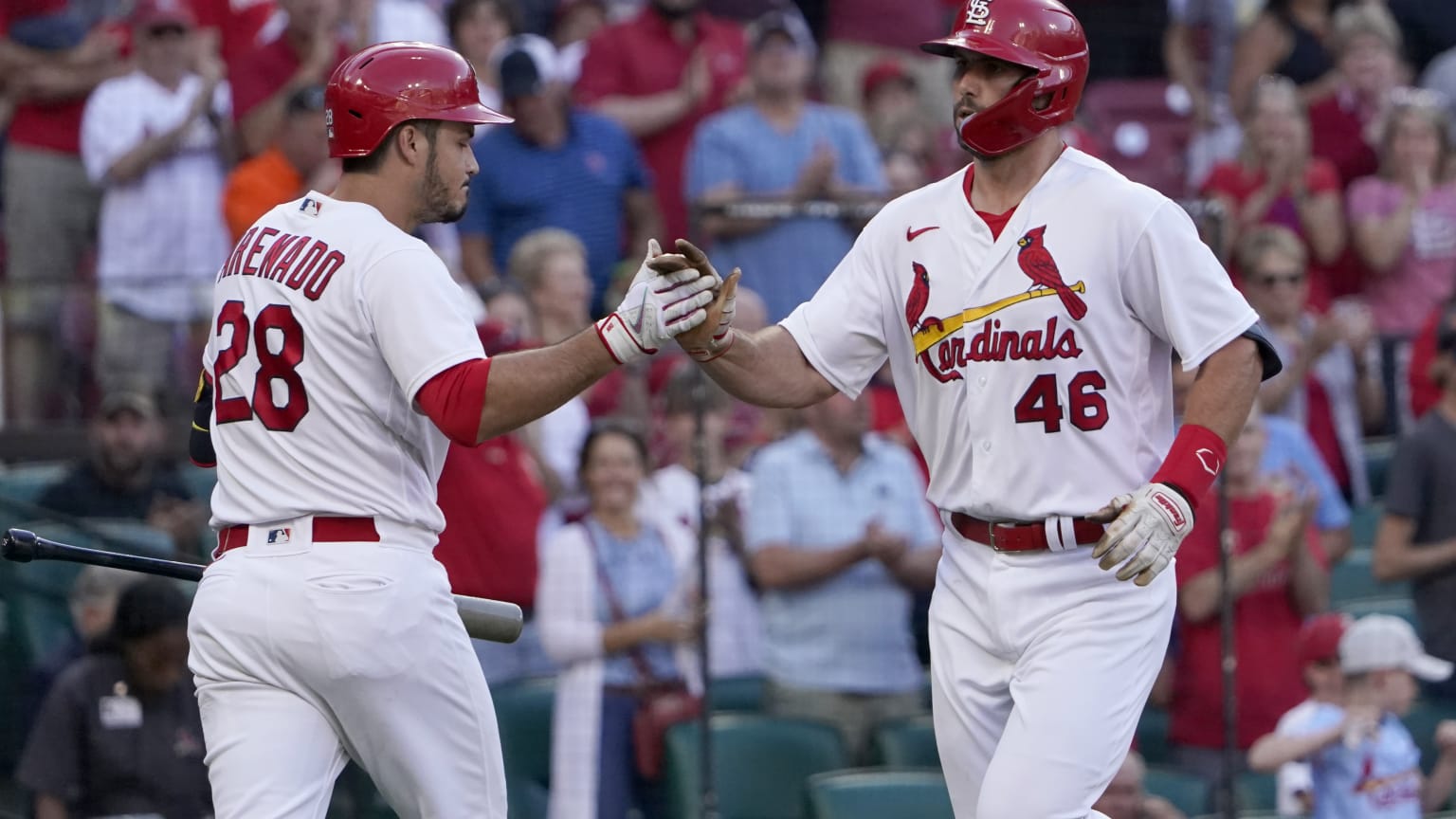 Two Cardinals players high-five after a home run