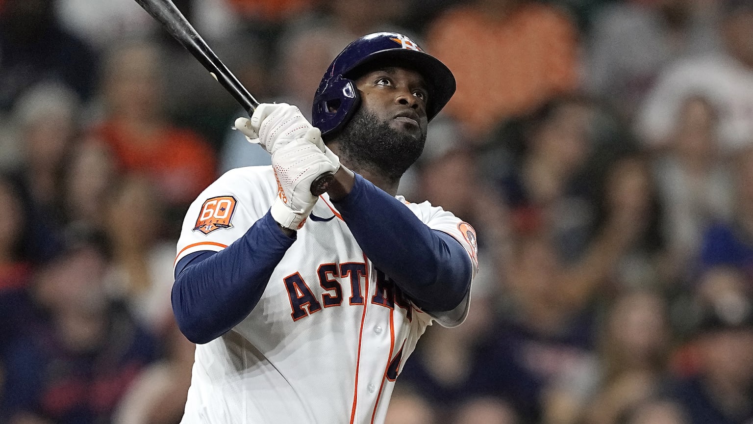 Yordan Alvarez follows through on a swing and follows the flight of the ball