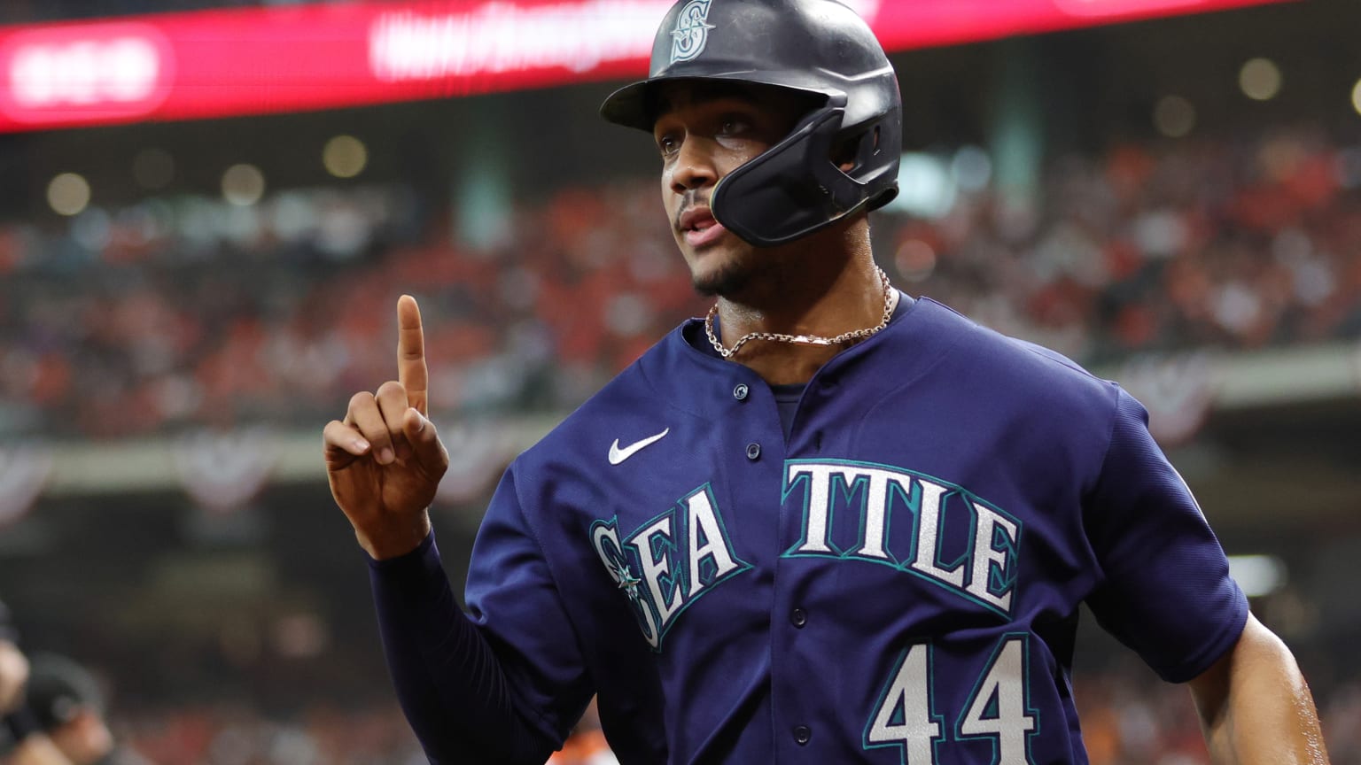 Julio Rodríguez holds up a finger as he returns to the dugout