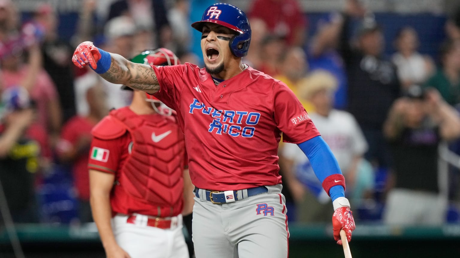 Javier Baez celebrates in a red Puerto Rico uniform