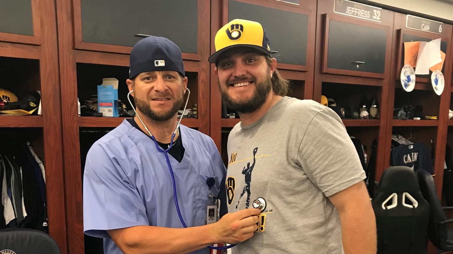 Two players in a clubhouse, one dressed like a doctor holding a stethoscope to the other's chest