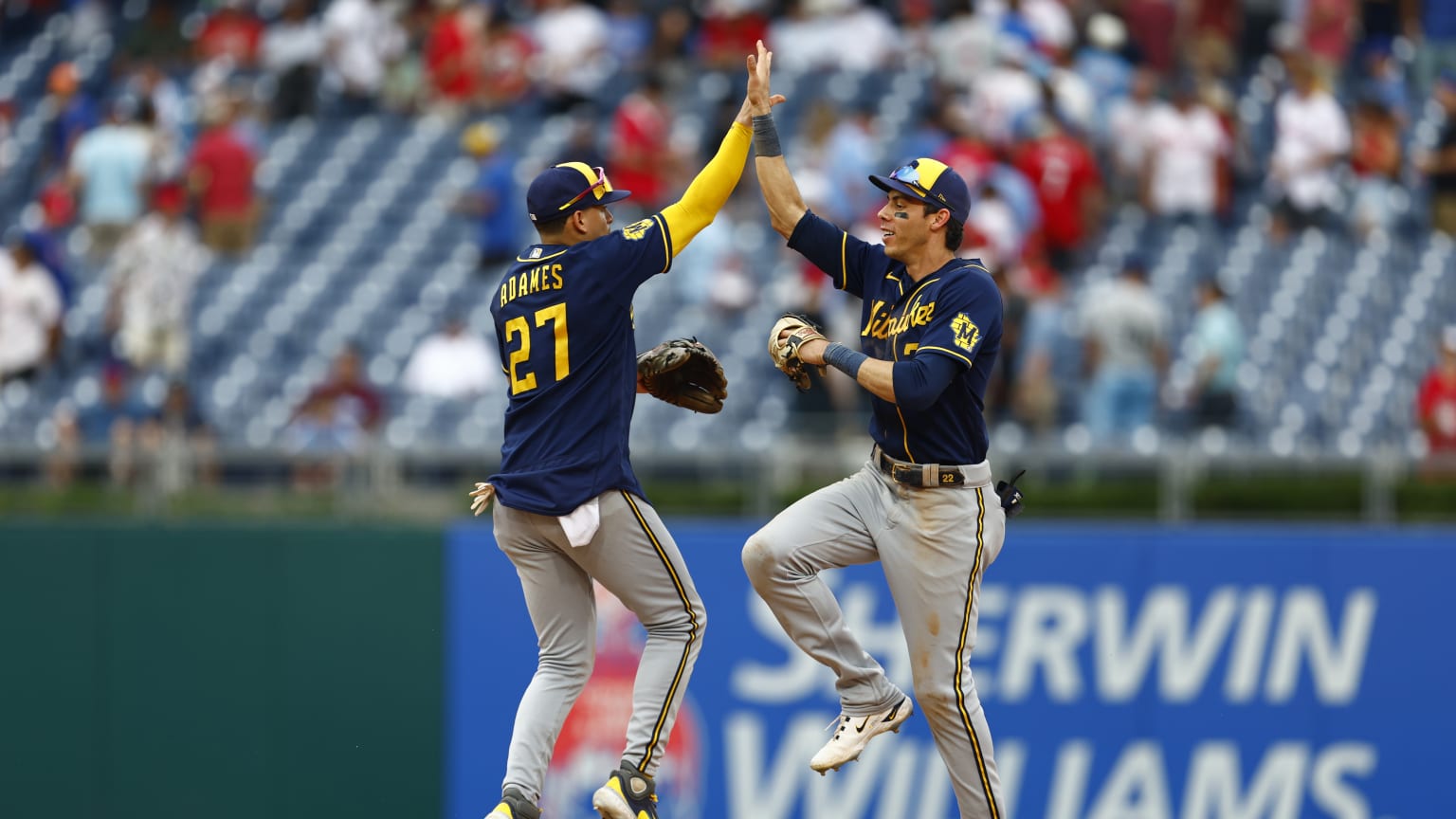 Willy Adames and Christian Yelich celebrate a Brewers win