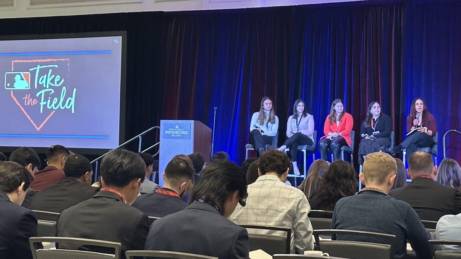 Five people on a stage during a panel discussion