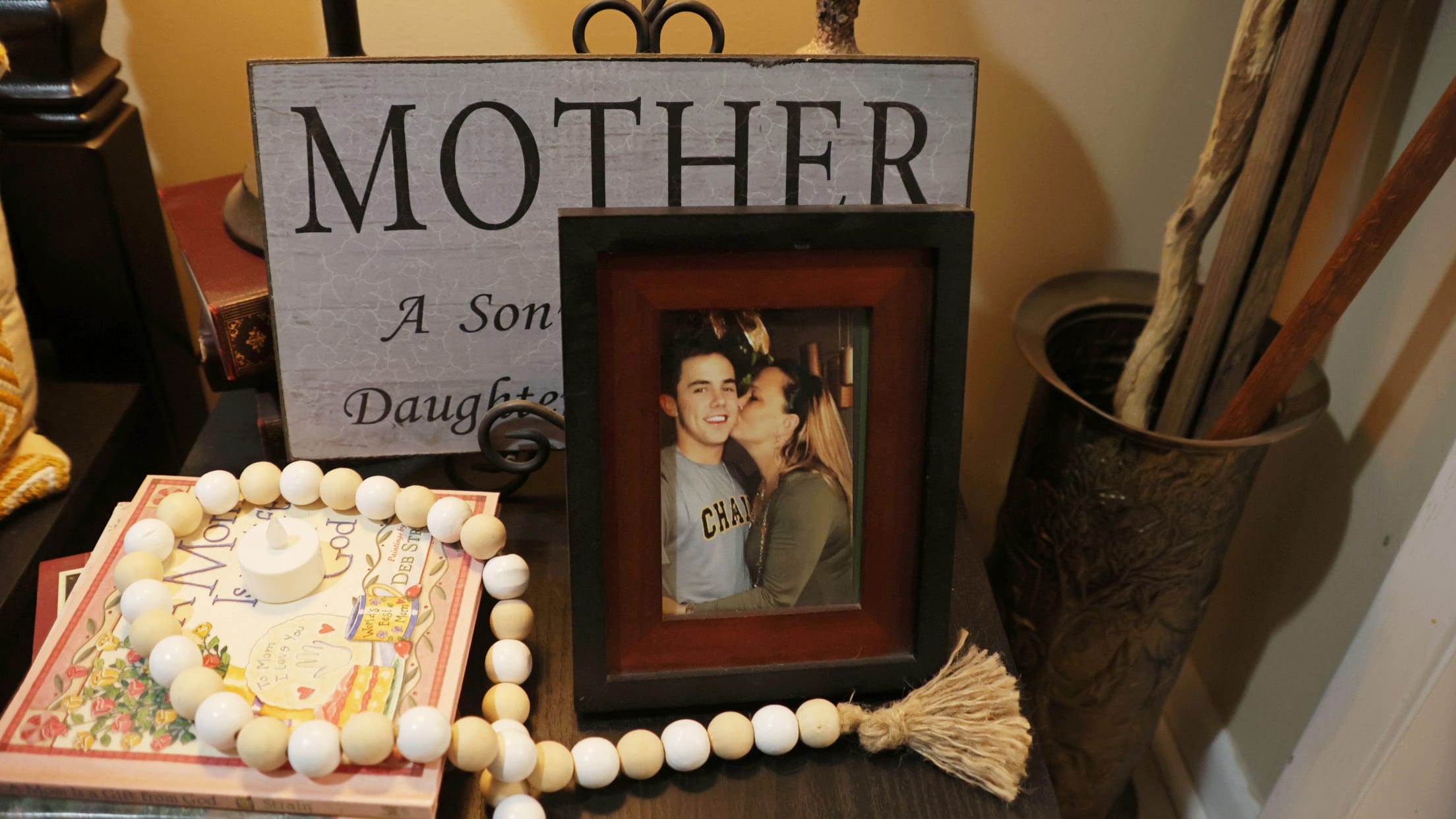 A photo of DL and his mom framed on a table.