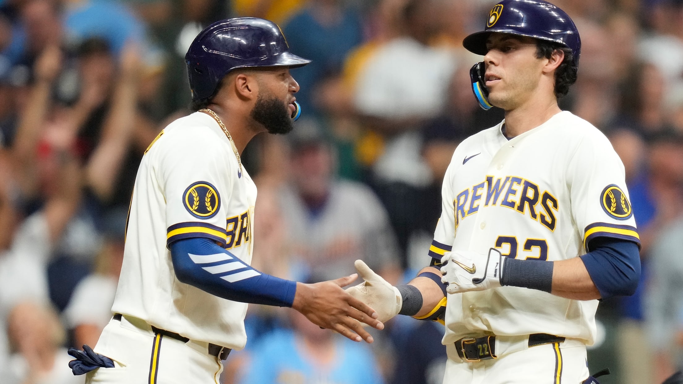 Jackson Chourio greets Christian Yelich at the plate