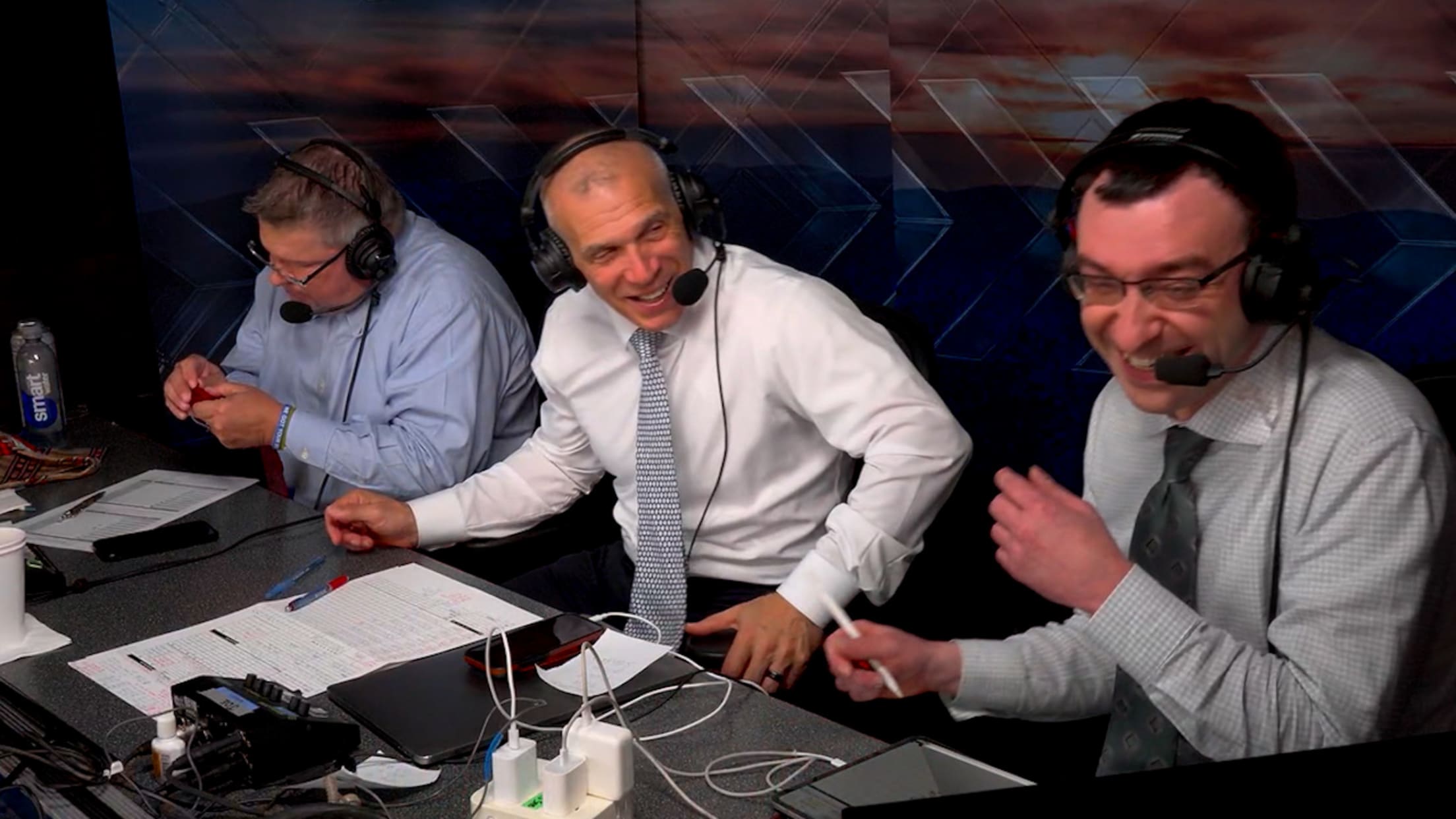 John Kruk fumbles with a tie as Joe Girardi and Jason Benetti laugh