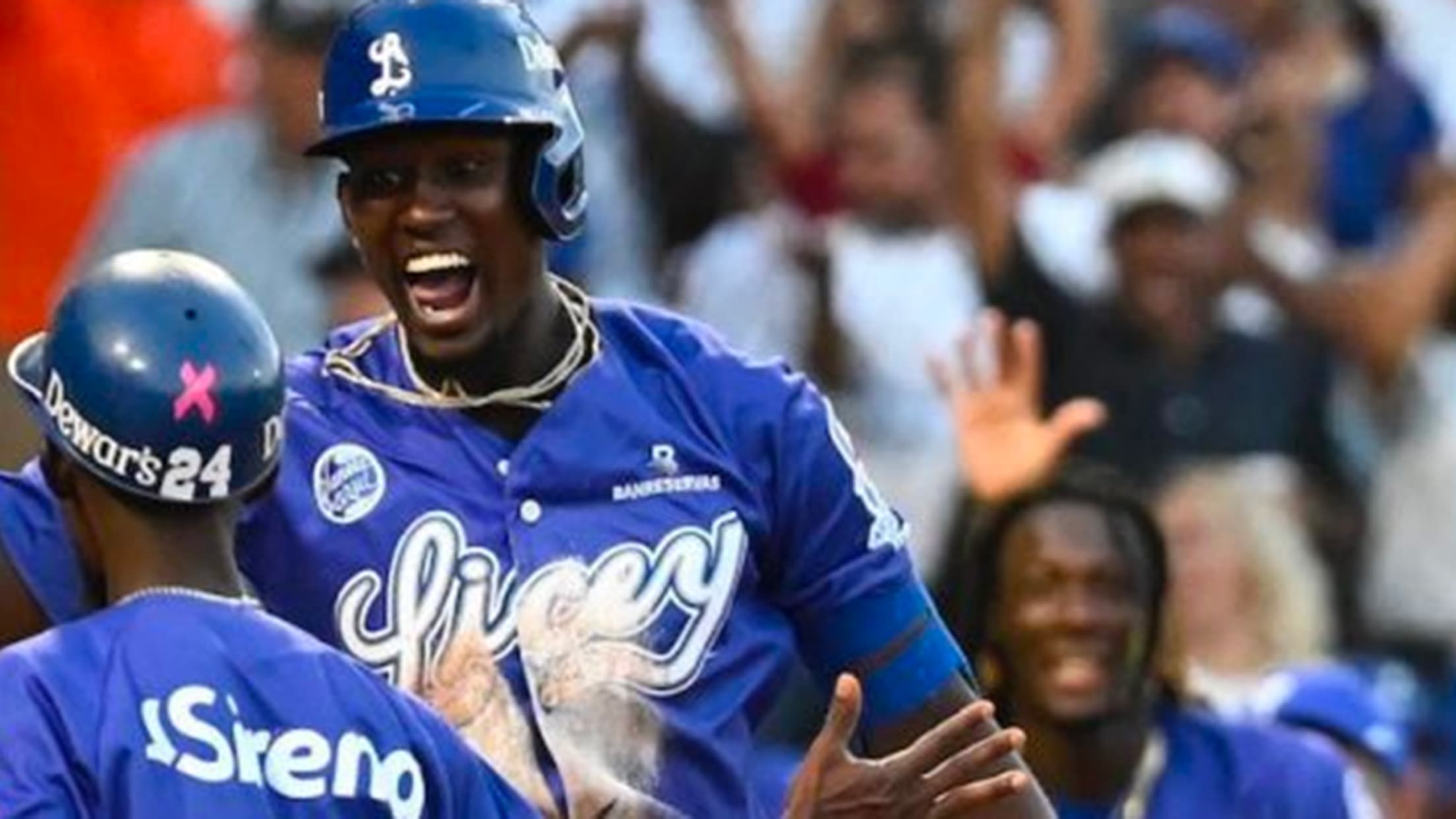 Players in blue jerseys reading ''Licey'' celebrate