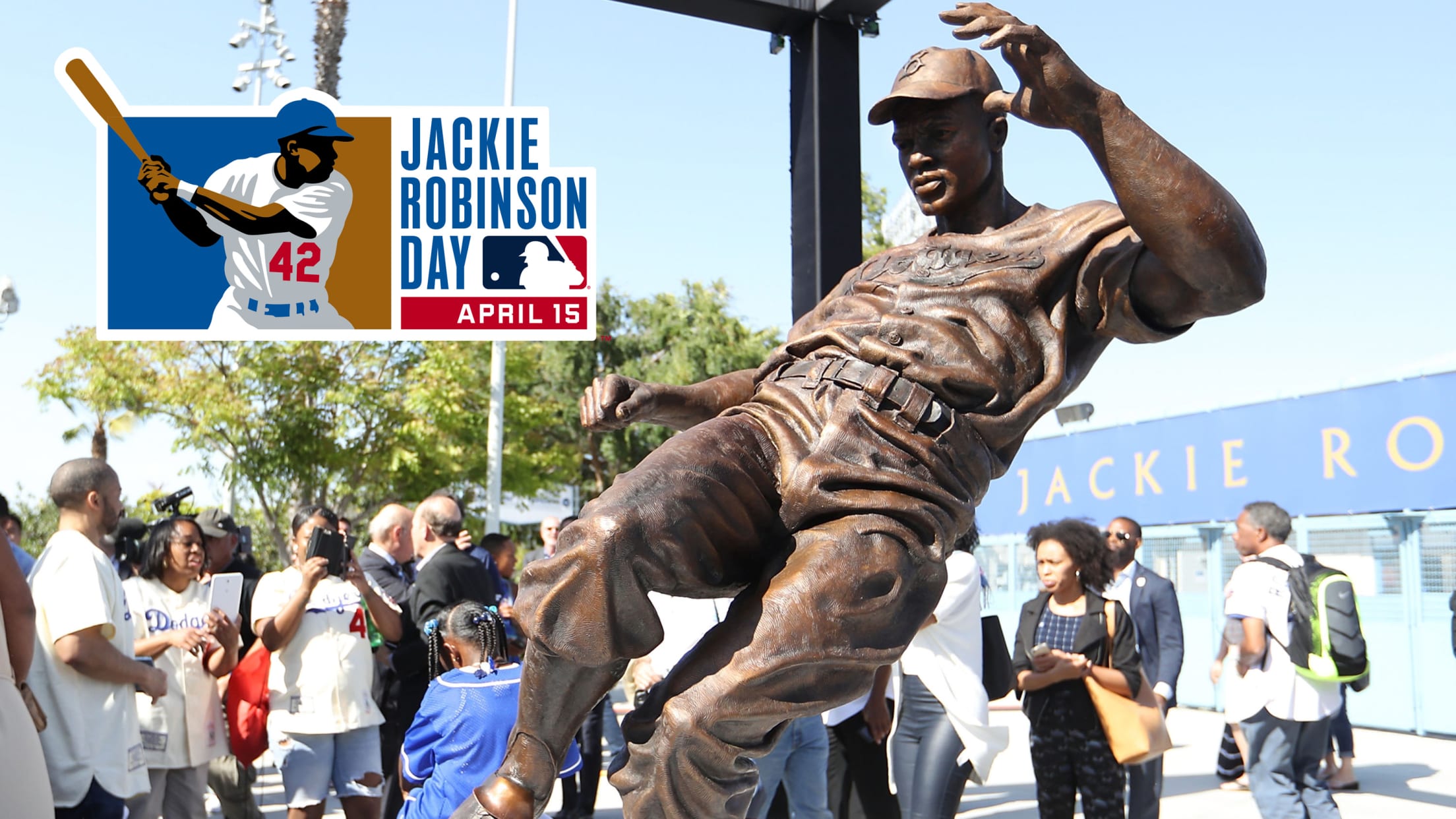 Fans take pictures of the Jackie Robinson Statue at Dodger Stadium