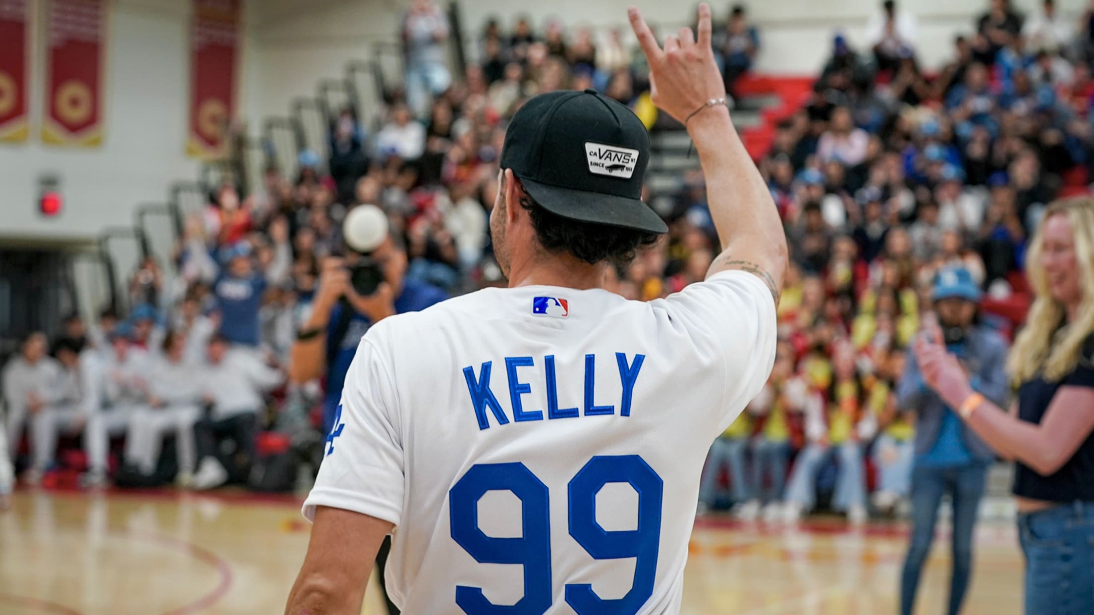 Joe Kelly waves to students at his former high school