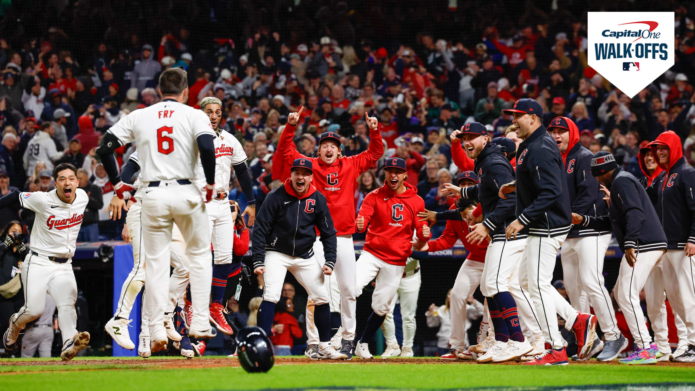 David Fry approaches his jubilant teammates at the plate after his walk-off homer