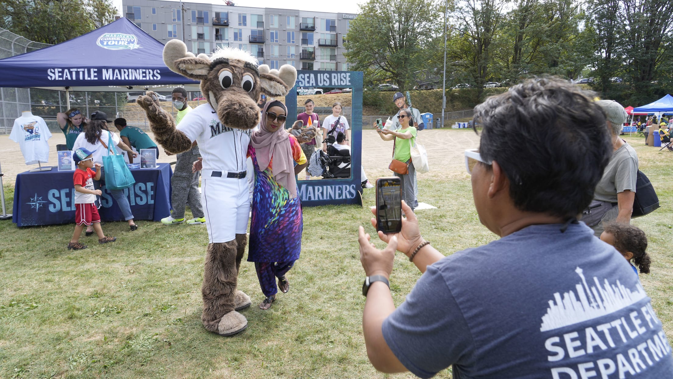 The Seattle Mariners' mascot, the Mariner Moose, greets a young