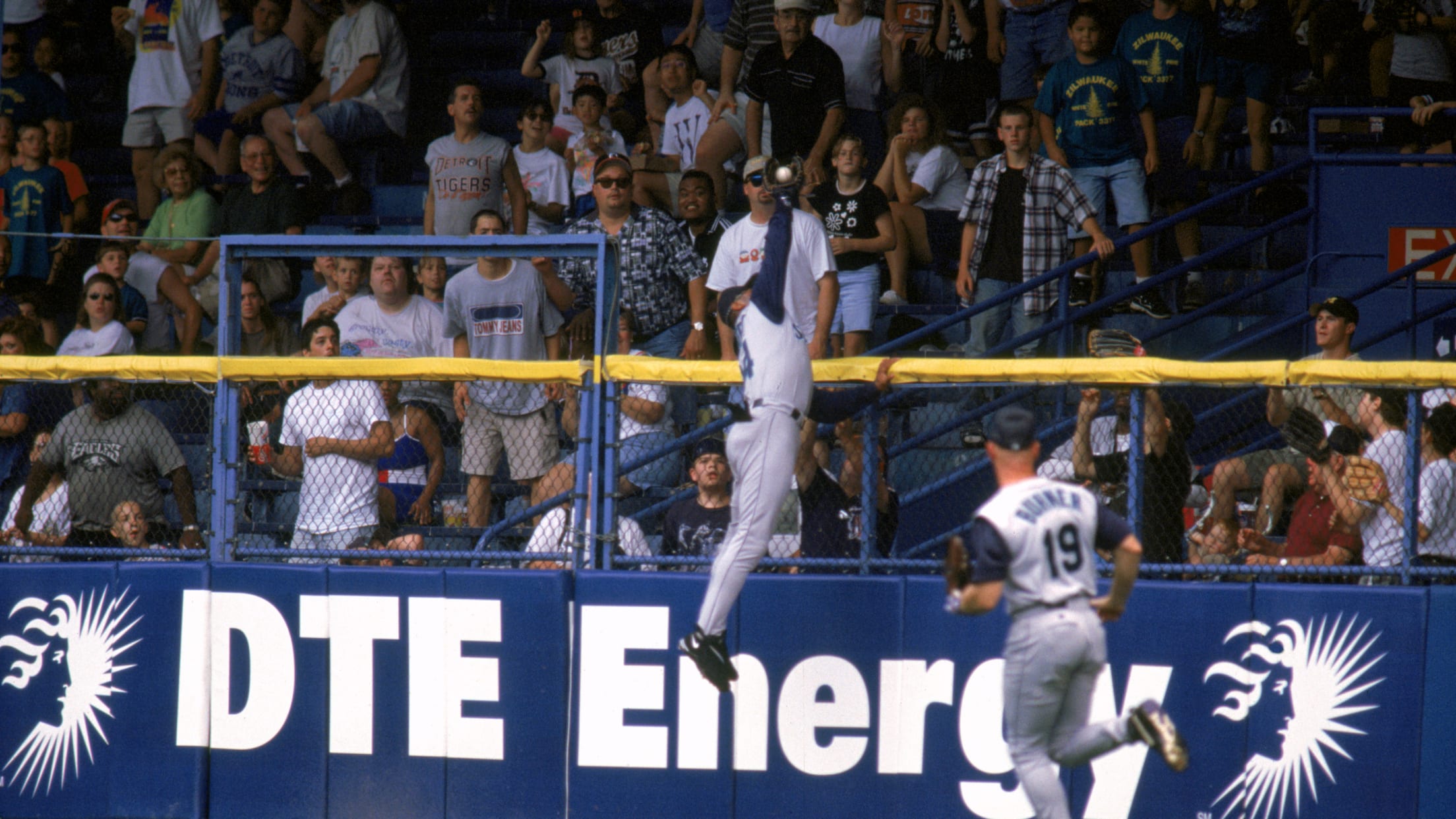 Ken Griffey Jr. rises high over the fence to rob a home run