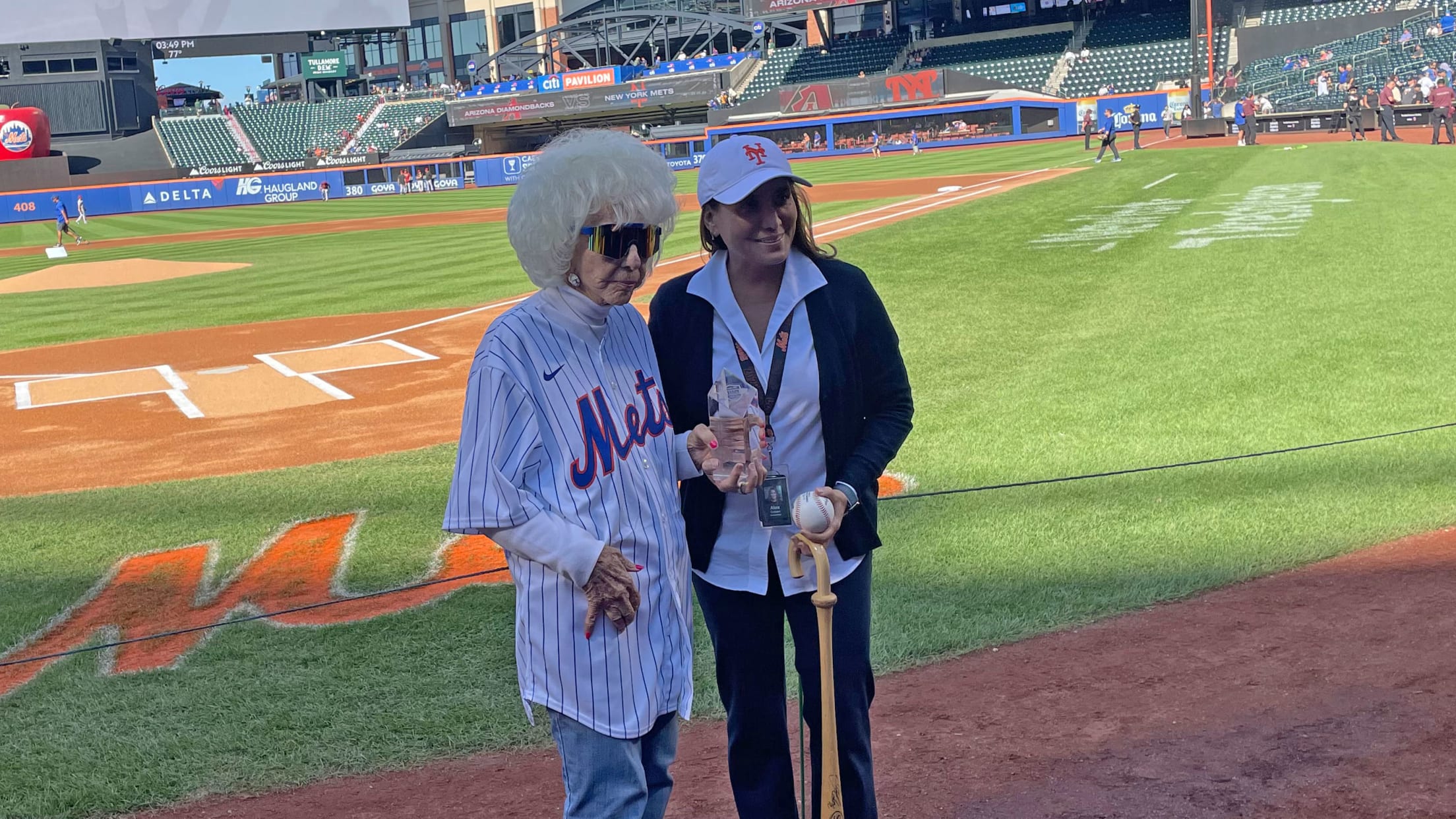 Maybelle Blair and Alex Cohen on the field before the Mets game