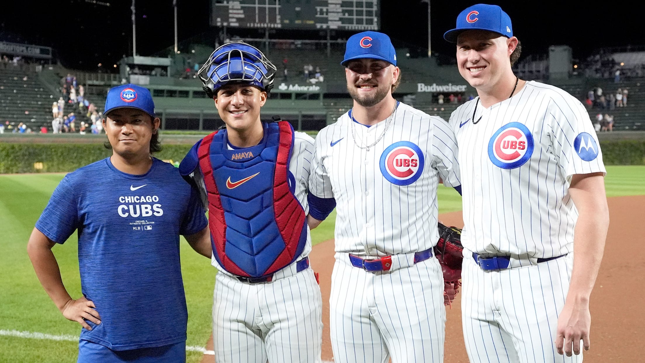 Starter Shota Imanaga poses postgame with catcher Miguel Amaya and relievers Porter Hodge and Nate Pearson