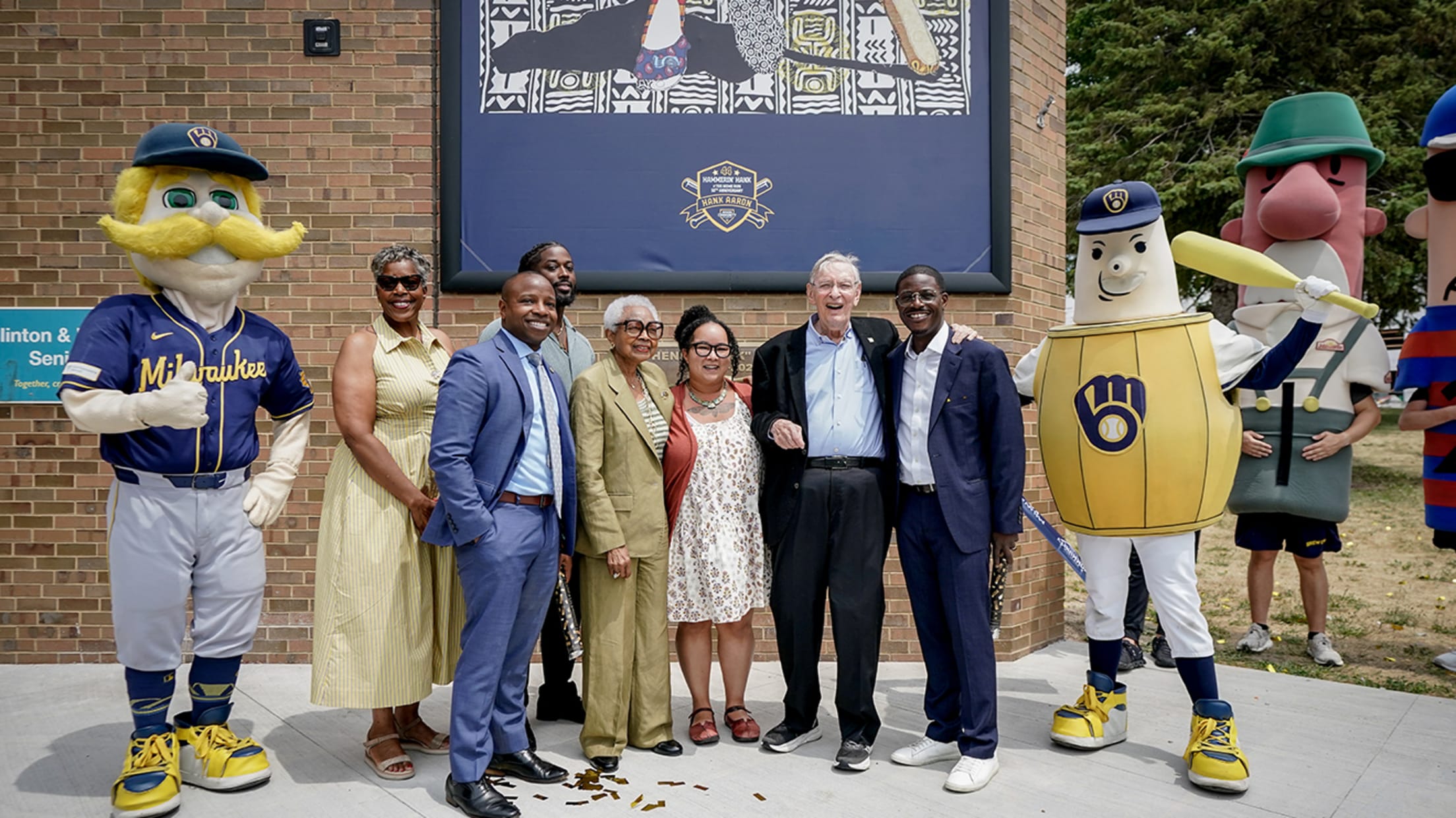 Hank Aaron's widow, Billye, with MLB Commissioner Emeritus Bud Selig, Brewers mascots and others at the mural unveiling in Milwaukee