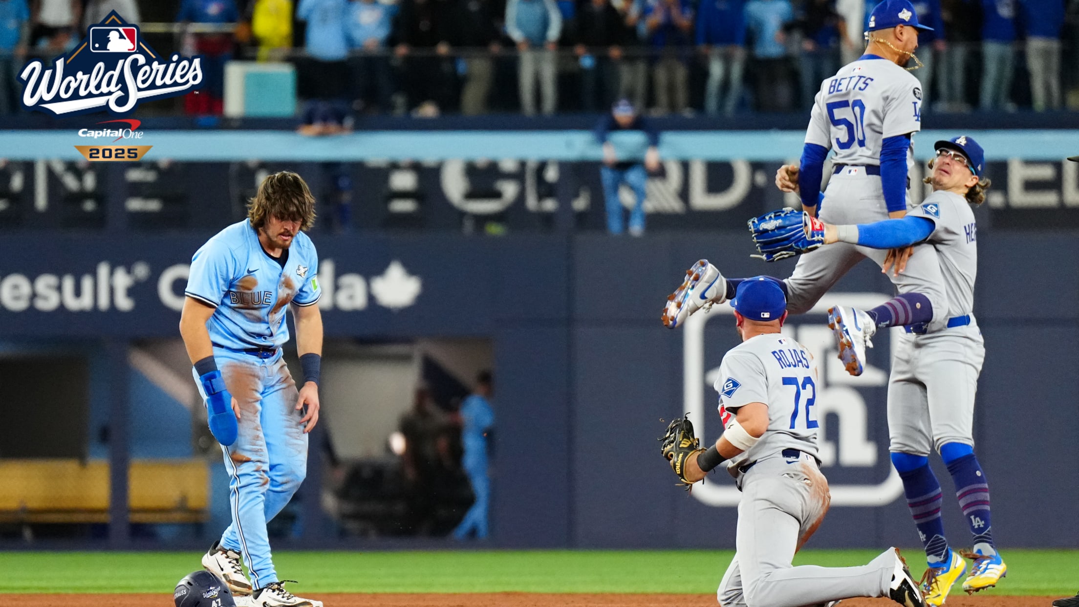 The Dodgers celebrate as Addison Barger stands on second base