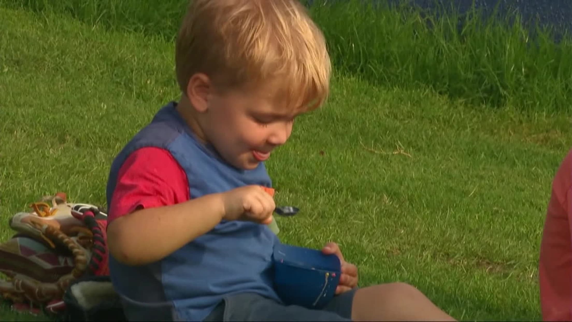 Adorable fan devours ice cream -- even off his shirt