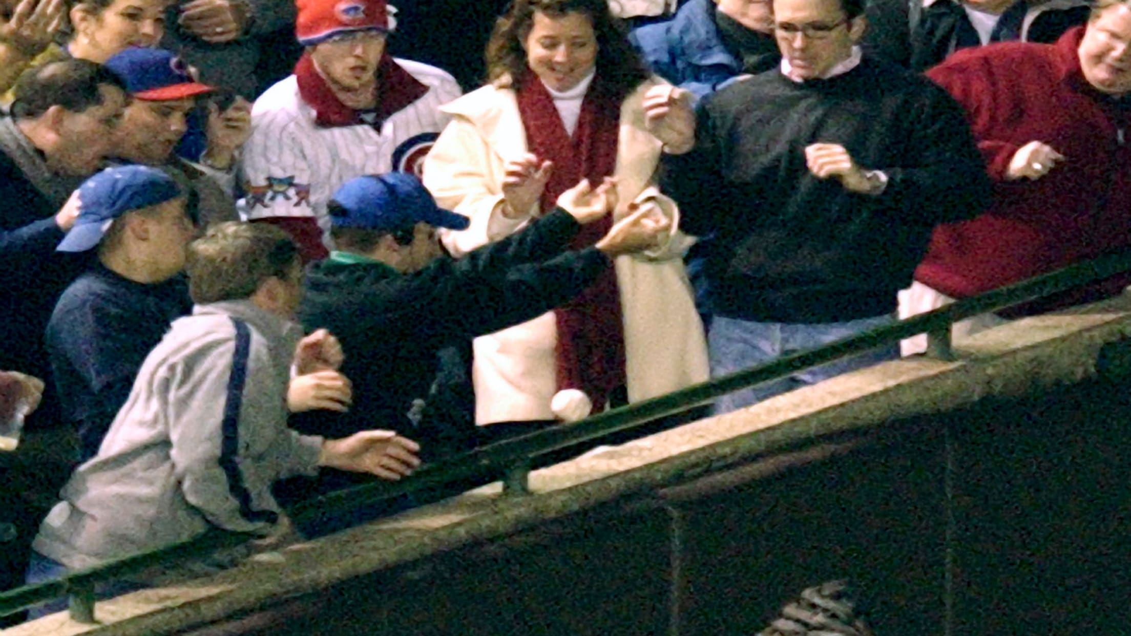 A fan wearing a Seattle Mariners jacket holds a Playoff bound