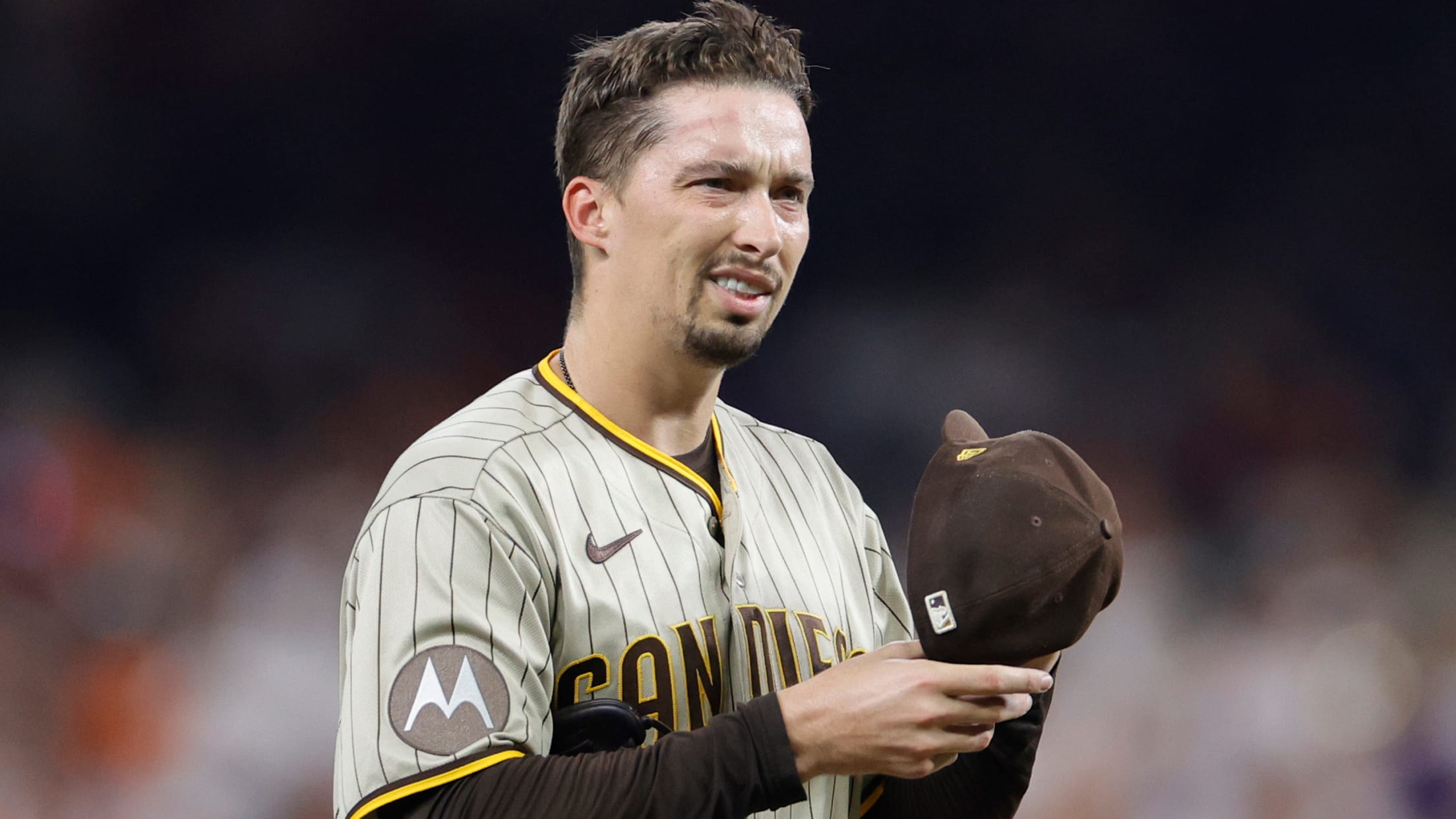 Blake Snell adjusts his cap with a puzzled look on his face